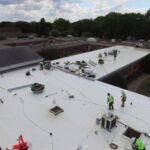 Roofers working on a commercial roofing project - Denali Roofing